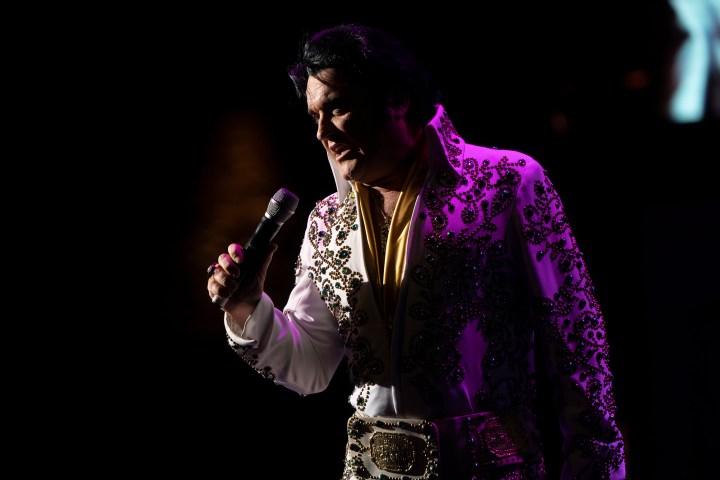 a person wearing a purple light in front of a stage