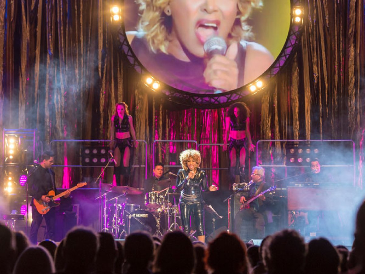 a group of people on a stage in front of a crowd