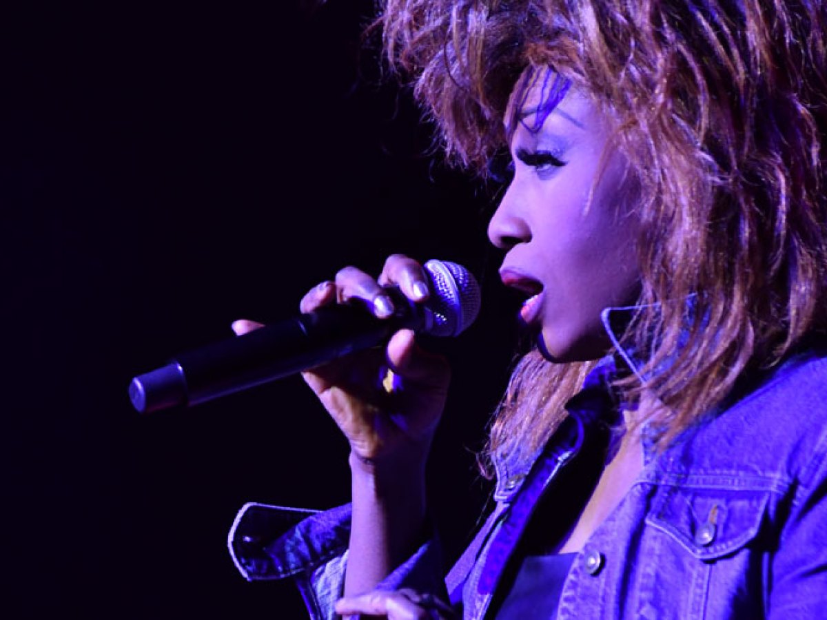 a woman talking on a stage