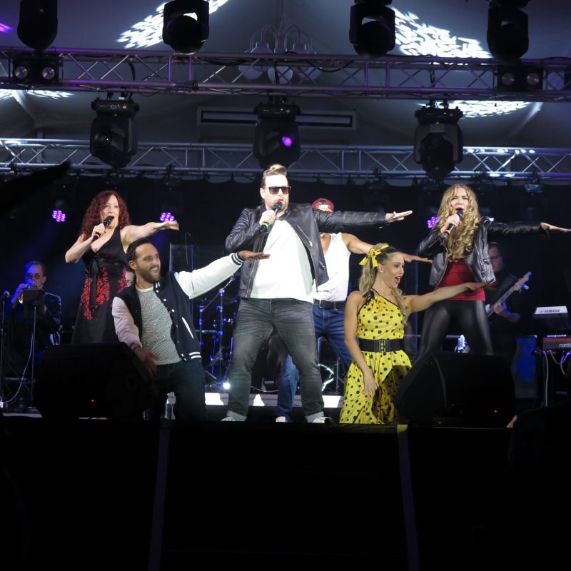 a group of people on a stage in front of a crowd