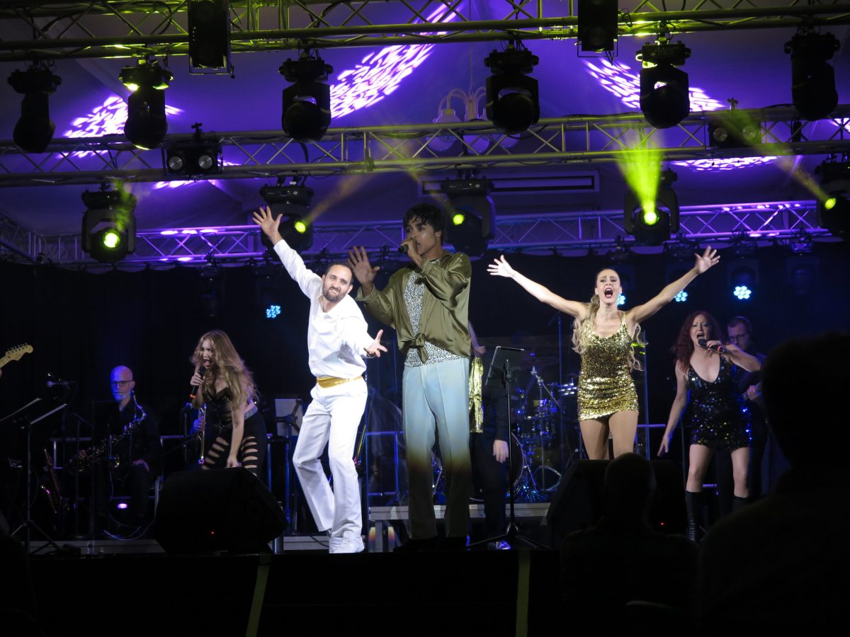 a man standing on a stage in front of a crowd