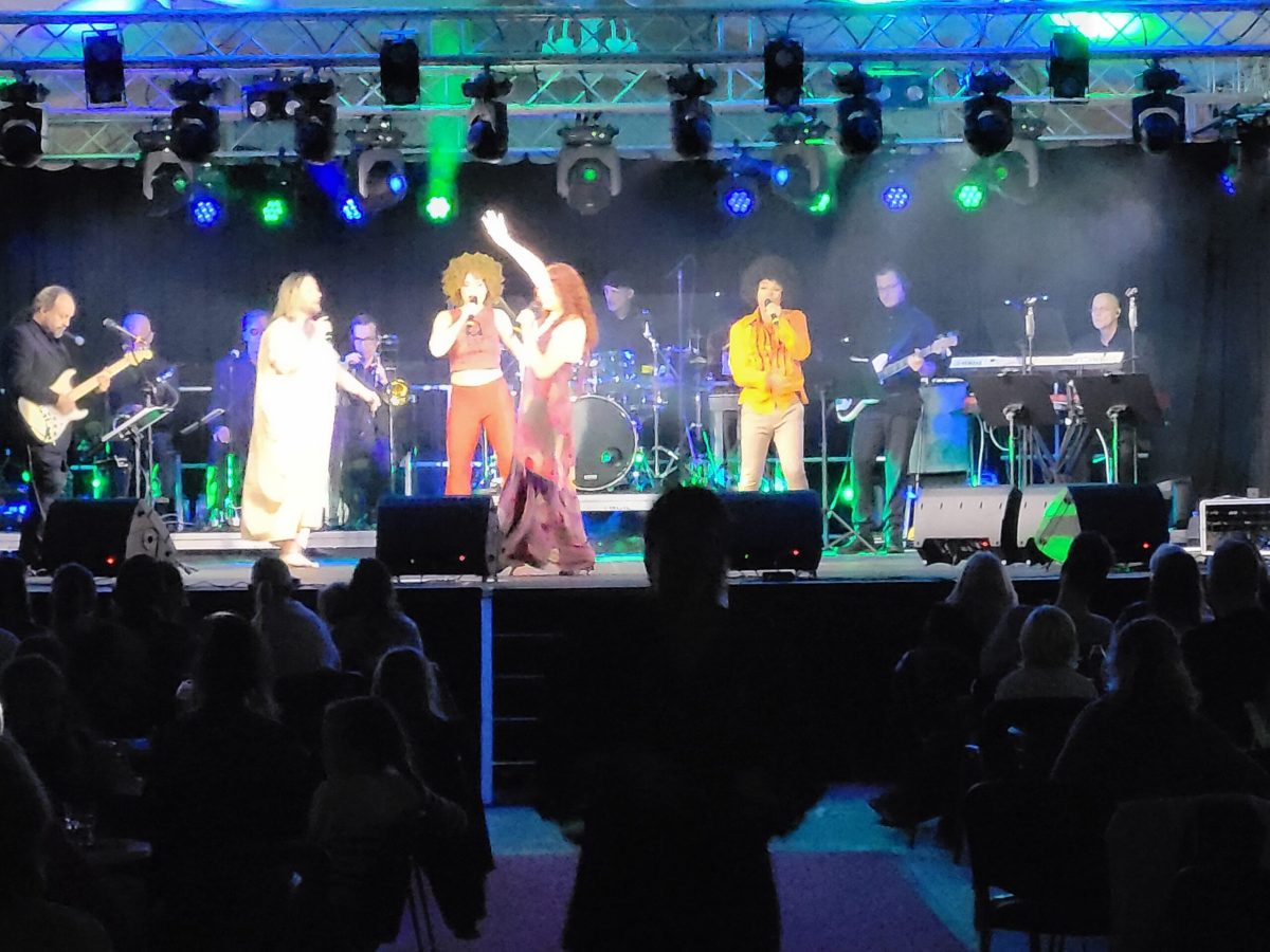 a group of people on a stage in front of a crowd