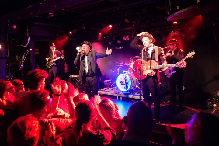 a group of people on a stage in front of a crowd