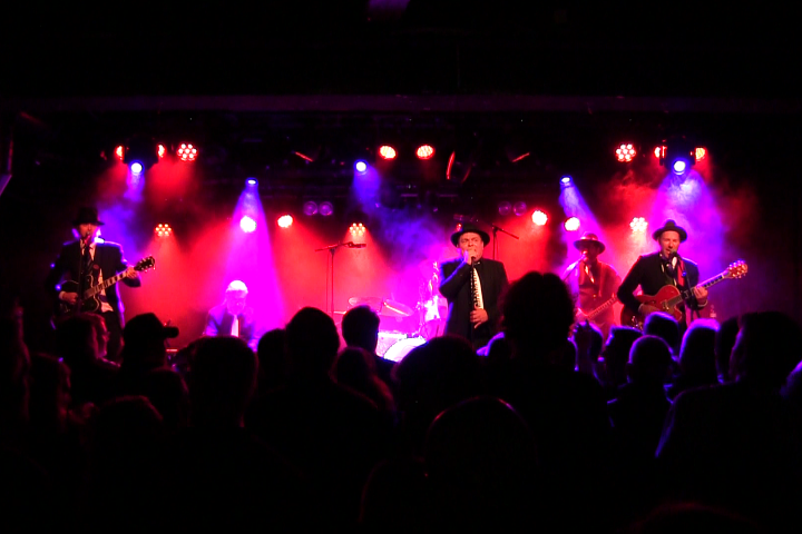 a group of people on a stage in front of a crowd