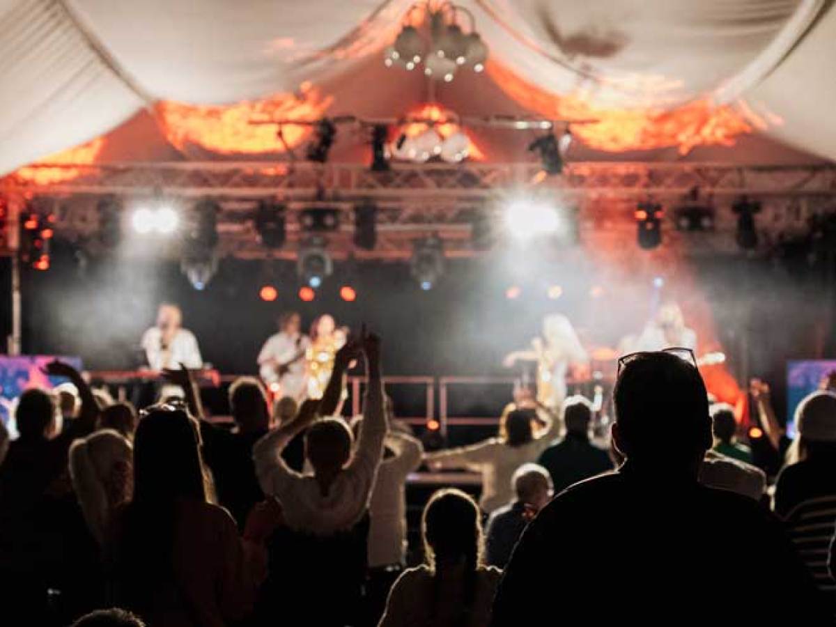 a group of people performing on stage in front of a crowd
