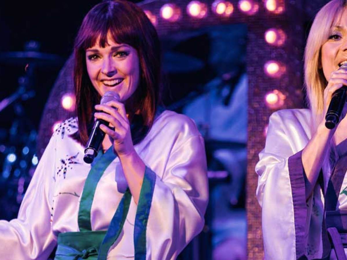 a person talking on a cell phone on a stage