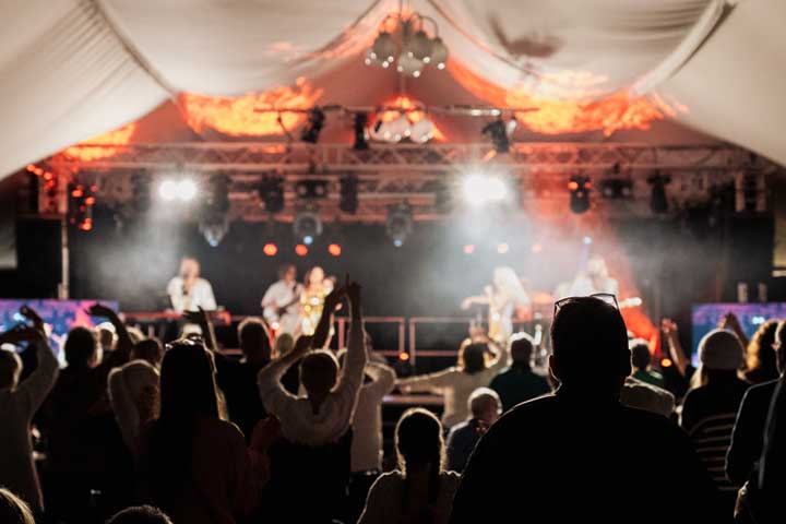 a group of people on a stage in front of a crowd