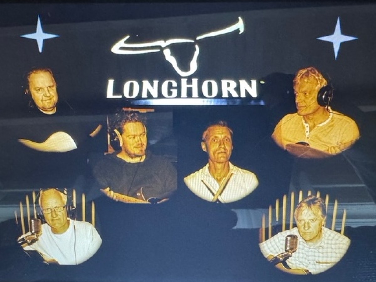 Six people with instruments under 'Longhorn' sign, wearing headphones.